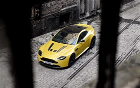 Aston Martin V12 Vantage S yellow supercar stop at street
