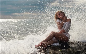 Blonde girl, white dress, sitting on the rocks, sea, waves, water splash