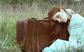 Girl in the grass, white dress, suitcase