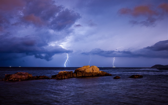 Sea, lightning, storm, stones, night, clouds Wallpapers Pictures Photos Images