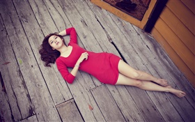 Asian girl lying on wooden floor, red dress